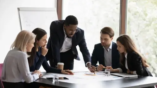 Group of professionals around desk