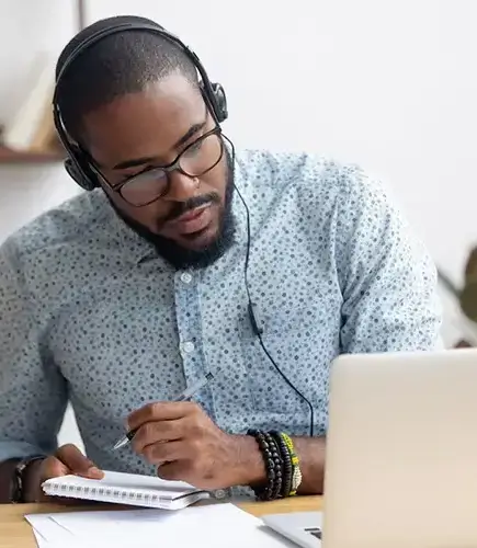 Man Working On Laptop With Headphone On (1)