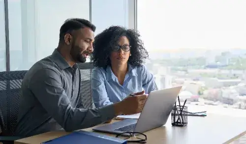 Man And Woman Sitting At Desk